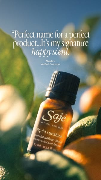 This ad promotes Saje Natural Wellness's Liquid Sunshine diffuser blend, highlighting a customer testimonial about i