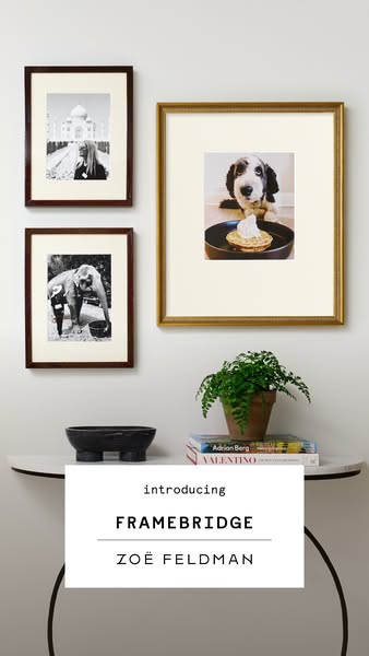 This image ad for Framebridge features a collection of framed photos hanging on a wall above a small table. The ad intro