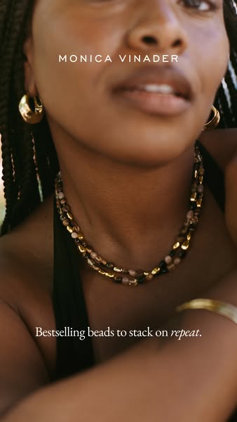 This ad for Monica Vinader features a close up of a woman wearing two beaded necklaces. The ad promotes the brand's 