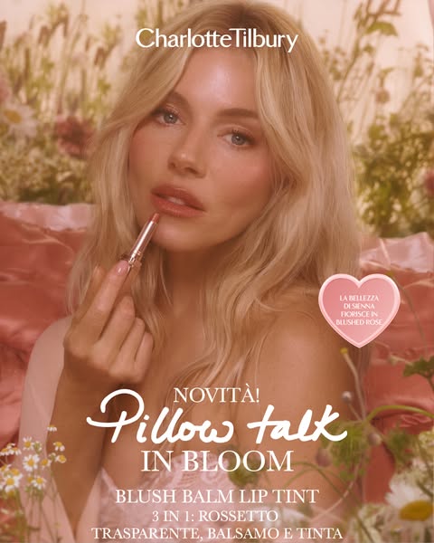 A lipstick is promoted with a female model using the lipstick with a floral background.