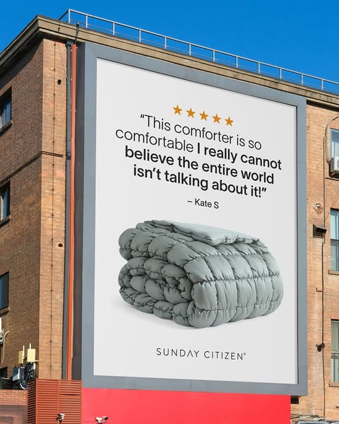 This ad features a billboard promoting a comfortable comforter from Sunday Citizen. The billboard displays a five-star r