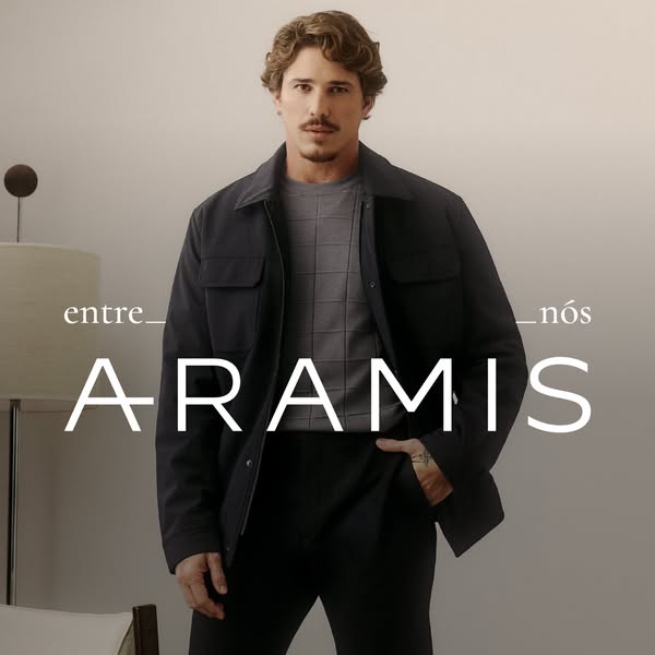 This ad features a man modeling clothes from Aramis. The ad has a luxury aesthetic, using a muted color palette.