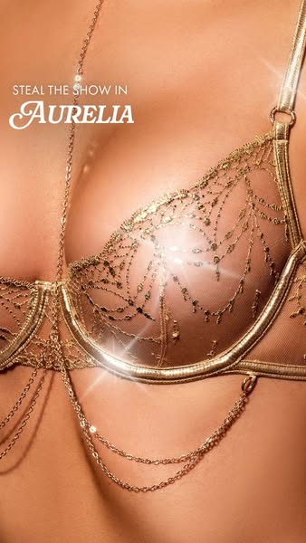 This ad promotes Aurelia lingerie, showcasing an ornate gold bra and body chain. The ad focuses on the luxurious and gla
