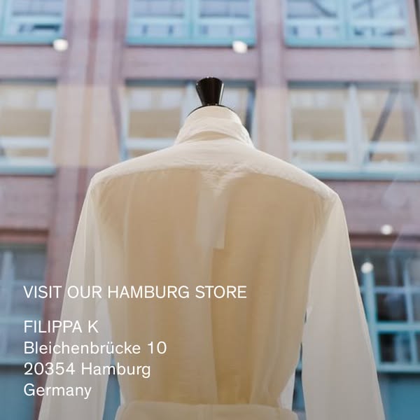 This ad promotes Filippa K's Hamburg store. The ad features a mannequin wearing a white shirt in the store's win