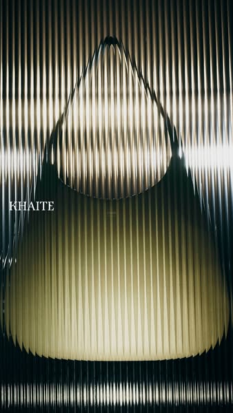 This ad features a Khaité brand handbag in front of a vertically ribbed background. The creative utilizes a monochromati