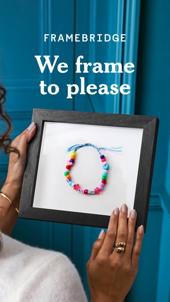 This ad for Framebridge features a woman holding a framed bracelet. The ad highlights the brand's ability to frame a