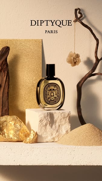Still life shot of Diptyque fragrance bottle surrounded by natural elements.