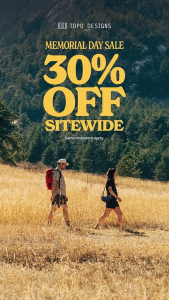 An image ad from Topo Designs promoting a Memorial Day sale, featuring a photo of two people hiking in a golden, grassy 