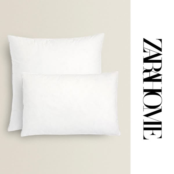 This ad showcases two white pillows from Zara Home.