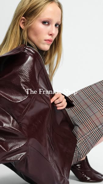 This ad showcases a model wearing a high-shine burgundy jacket, paired with plaid pants and matching boots from The Fran