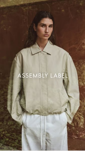 This ad for Assembly Label showcases the brand's neutral jacket worn by a female model.