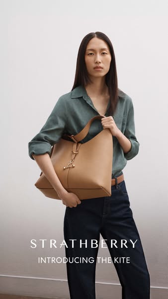 This ad showcases the Strathberry Kite bag, highlighting its design and style.