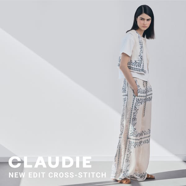 The ad showcases a woman wearing clothing with a cross-stitch design, emphasizing the brand's 'New Edit Cross-St