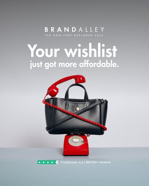The ad showcases a designer sale from BrandAlley using a luxury handbag placed on top of a vintage red telephone to high