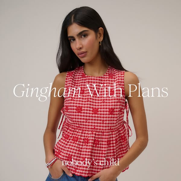 This ad features a model wearing a Nobody's Child gingham top. The text overlay reads, "Gingham With Plans.&quo