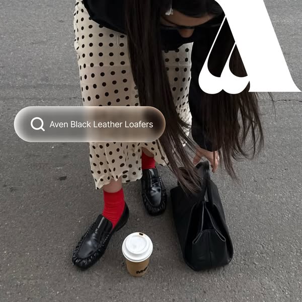This ad displays Aven black leather loafers being worn, in an outdoor setting. A search bar overlay suggests that the st