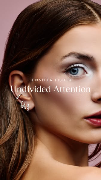 This ad showcases Jennifer Fisher jewelry, specifically earrings, on a model.