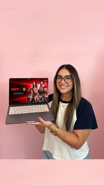 This ad features a woman presenting a laptop that is displaying a WWE and ESPN partnership advertisement. The ad aims to