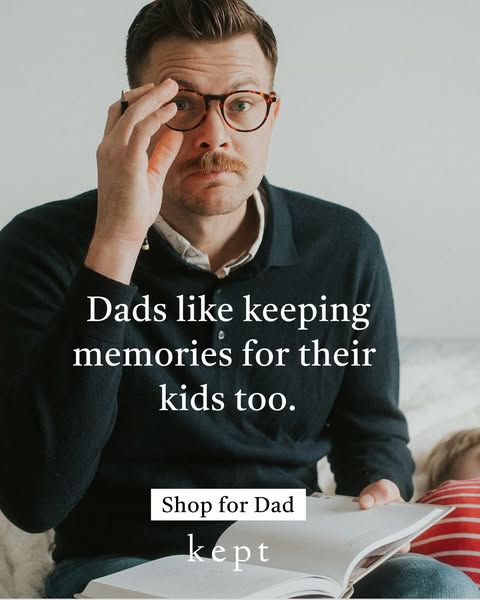 This image ad is for Kept photo albums. It features a father looking into the camera while reading a book with a child. 