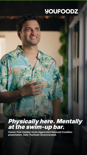 An image ad for Youfoodz showing a man in a tropical shirt. The ad's tagline is "Physically here. Mentally at t