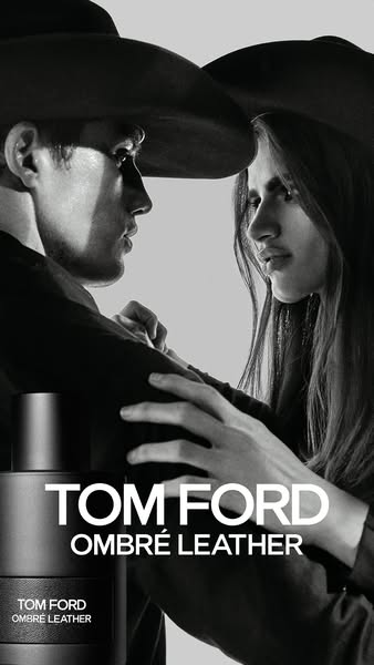 This ad features a black and white image of a man and woman wearing hats, with a bottle of Tom Ford Ombré Leather cologn