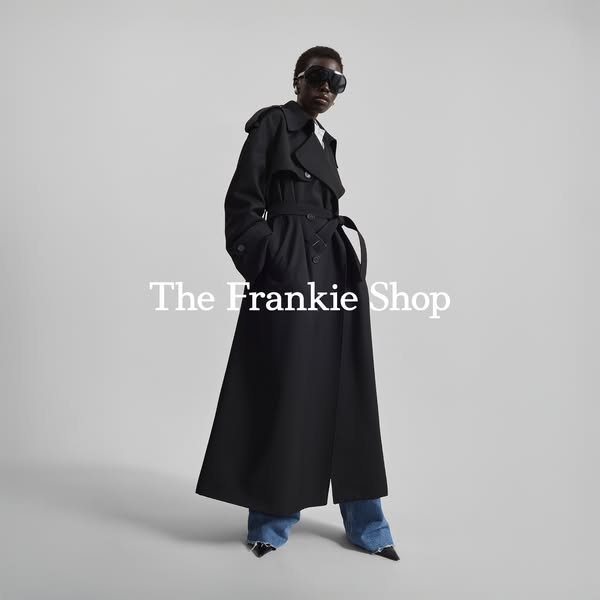 This ad features a woman wearing a black trench coat from The Frankie Shop. The shot is clean and focuses on the brand&#