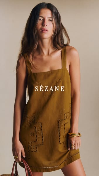 This is a product ad for a linen dress with lace cutout detailing from Sezane.