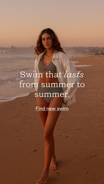 This image ad features a woman on a beach wearing a green two-piece swimsuit and an unbuttoned white shirt. The ad promo