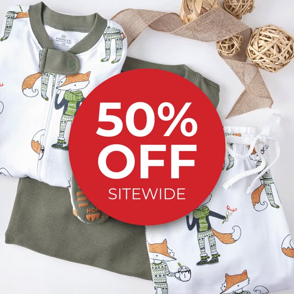 This image ad for The Honest Company promotes a 50% off sitewide sale, featuring a playful image of children's pajam