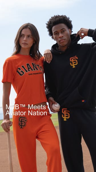 This ad features a man and a woman wearing matching clothing from the MLB™ Meets Aviator Nation line. The clothing featu