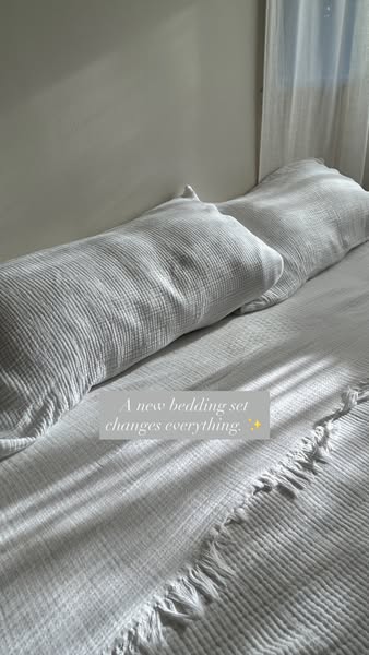 This ad features a close-up shot of a bed with textured white bedding and pillows, accompanied by the headline, "A 
