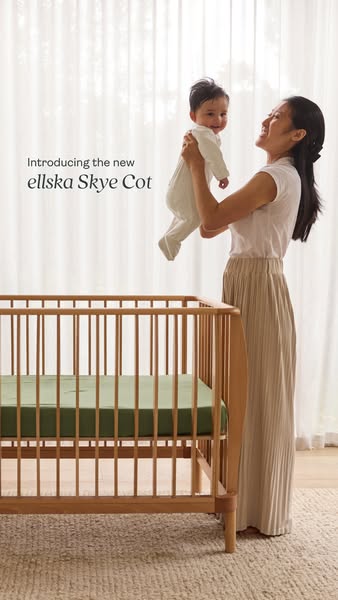 This ad features a woman holding a baby next to the ellska Skye Cot. The ad is introducing the new ellska Skye Cot.