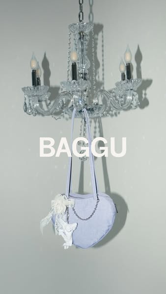 This ad showcases a light purple Baggu heart-shaped bag hanging from a chandelier.