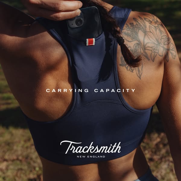 This image ad for Tracksmith apparel features a woman's sports bra with a built-in phone pocket. The ad highlights t