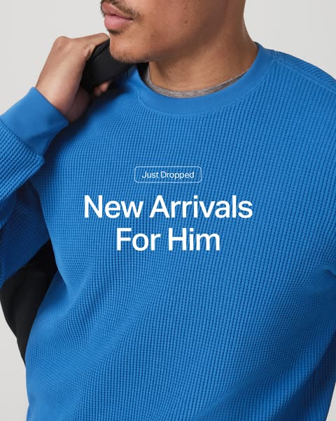 This ad features a man wearing a blue textured FIGS sweater. A caption above the man reads "Just Dropped" and 