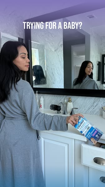 This ad features a woman in her bathroom, dressed in a robe, reaching into a drawer to grab a Clearblue pregnancy test. 