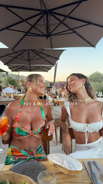 This image ad is promoting a brand and features two women who are smiling and looking at each other. They are sitting at