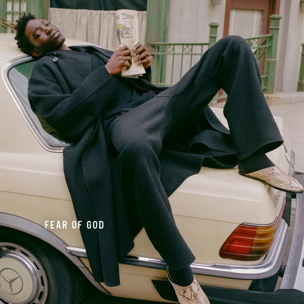 This ad features a man in Fear of God clothing, reclining on a car while reading a newspaper. The ad focuses on the bran