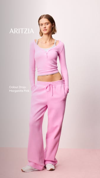 This image ad features a woman modeling a matching top and sweatpants outfit to promote a new color release.