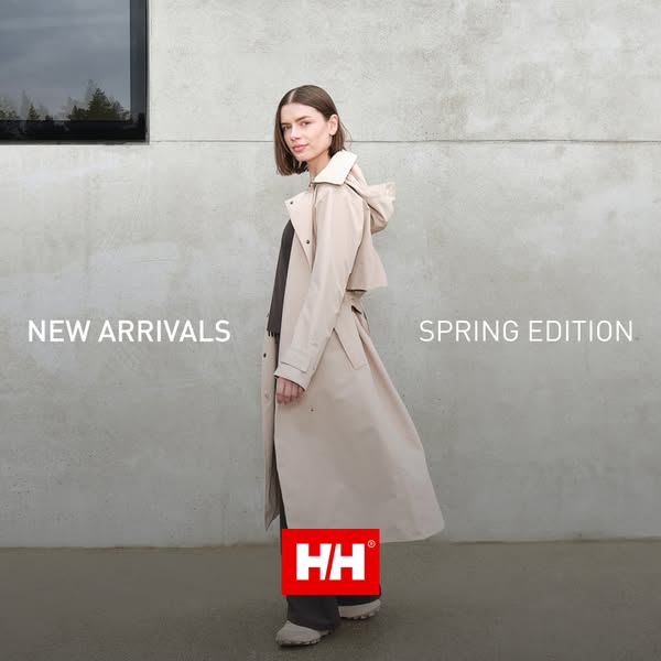 This image ad by Helly Hansen displays a woman in an outdoor setting modeling their new spring edition trench coat. The 