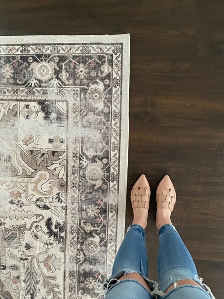 This ad features a person standing on a vintage-style rug, showcasing its design and texture.