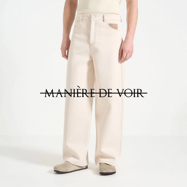 Image ad for Manière De Voir featuring a pair of wide-legged cream-colored pants. The image focuses on the pants, showca
