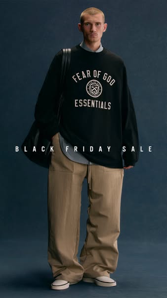 This image ad promotes the Fear of God Essentials brand, highlighting a Black Friday sale. A man is shown wearing a blac