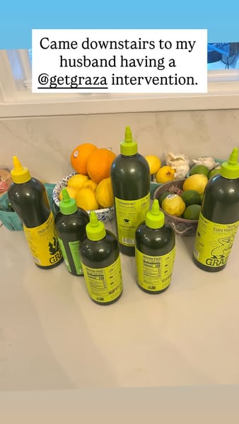 This ad features a photo of several bottles of Graza olive oil surrounded by fruit. The photo is captioned with a humoro