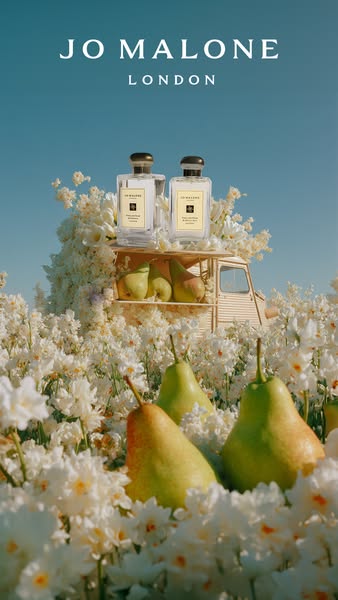 This Jo Malone ad features two bottles of perfume on top of a miniature van surrounded by white flowers and pears, creat
