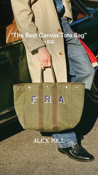 This ad features an olive green canvas tote bag from Alex Mill, personalized with the letters "FRA." It highli