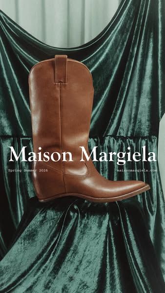 This image ad features a single Maison Margiela cowboy boot positioned in front of a draped green velvet background. The