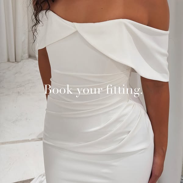 This ad promotes a wedding dress fitting. It features a close-up shot of a woman wearing a white wedding dress and inclu