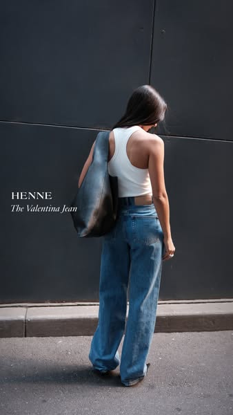This ad features an image of a woman wearing a pair of blue jeans while standing against a dark gray wall. The product i