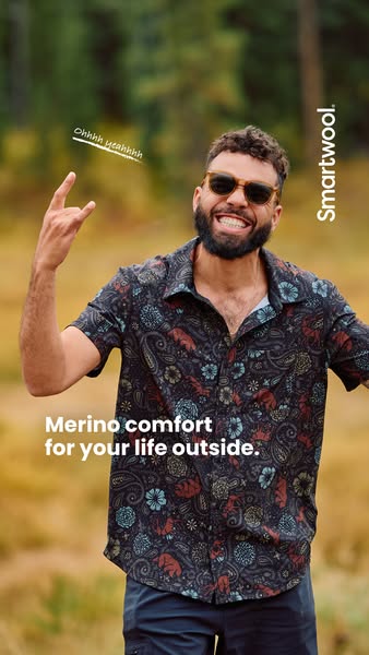 This ad features a man outdoors wearing a short-sleeved collared shirt and promotes the comfort of Smartwool clothing fo